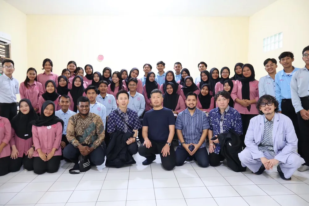 Participants posing with students at a Japanese language school