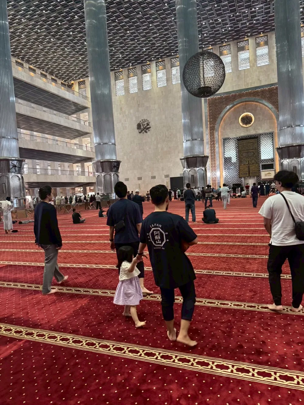 Participants walking through a large mosque in Indonesia