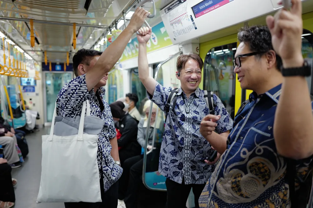 Participants travelling together on public transport in Jakarta